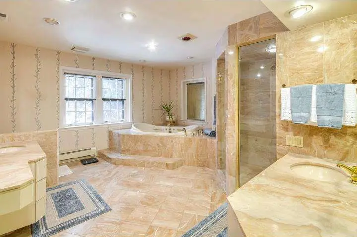 Large bathroom with stone counter and floors
