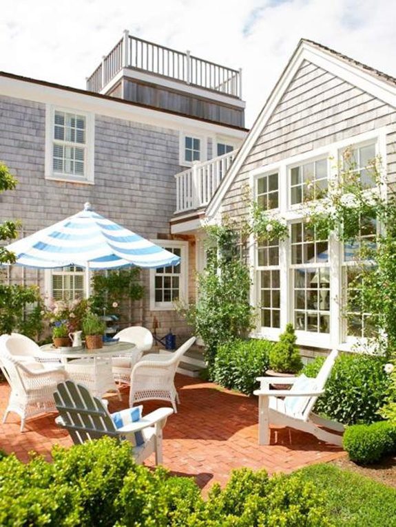 Rustic patio with white outdoor furniture. summer outdoor decor trends